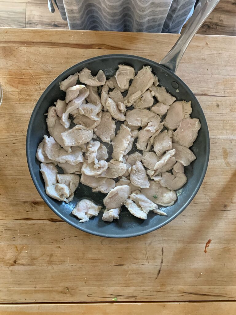 Cooked, thinly sliced chicken breast in skillet