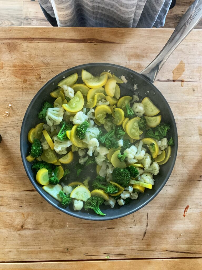 Cooked squash, broccoli, and cauliflower in skillet