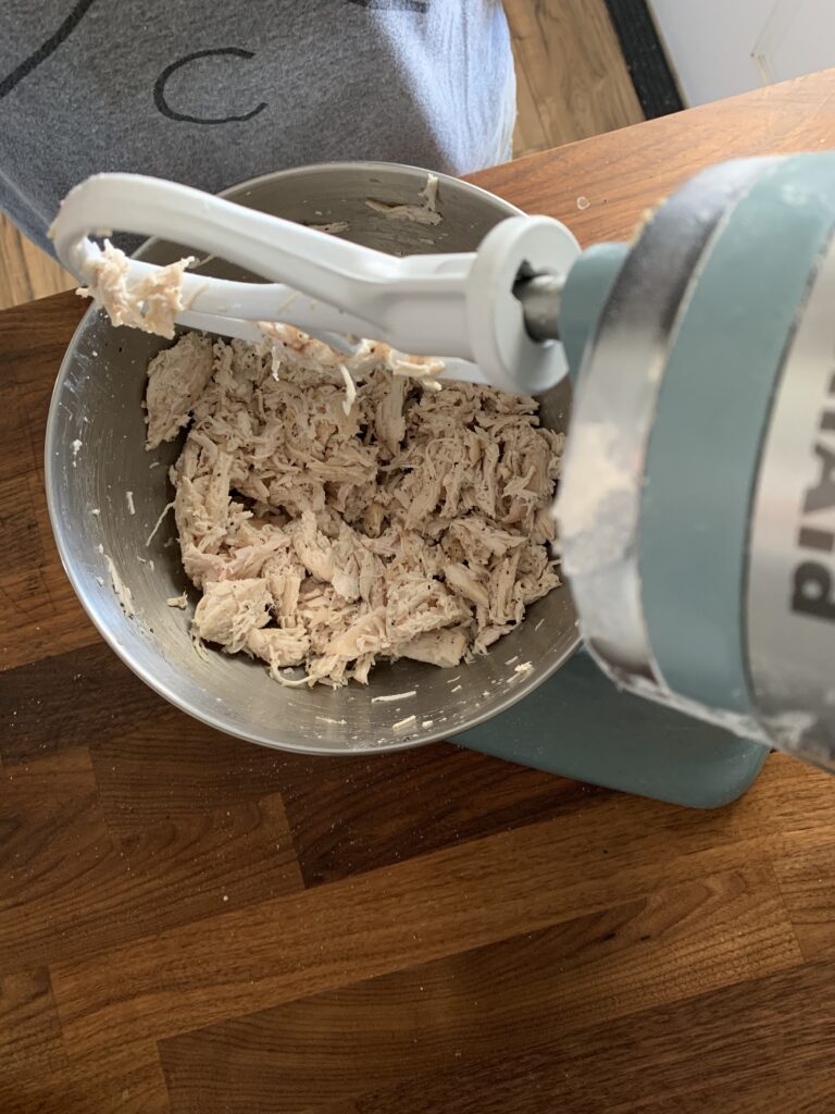 Shredded chicken in a kitchen aid mixer