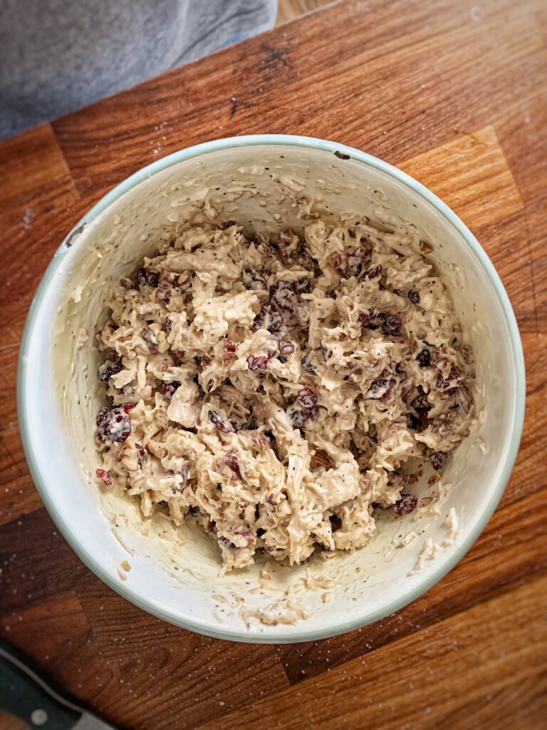 Honey pecan chicken salad in a white mixing bowl