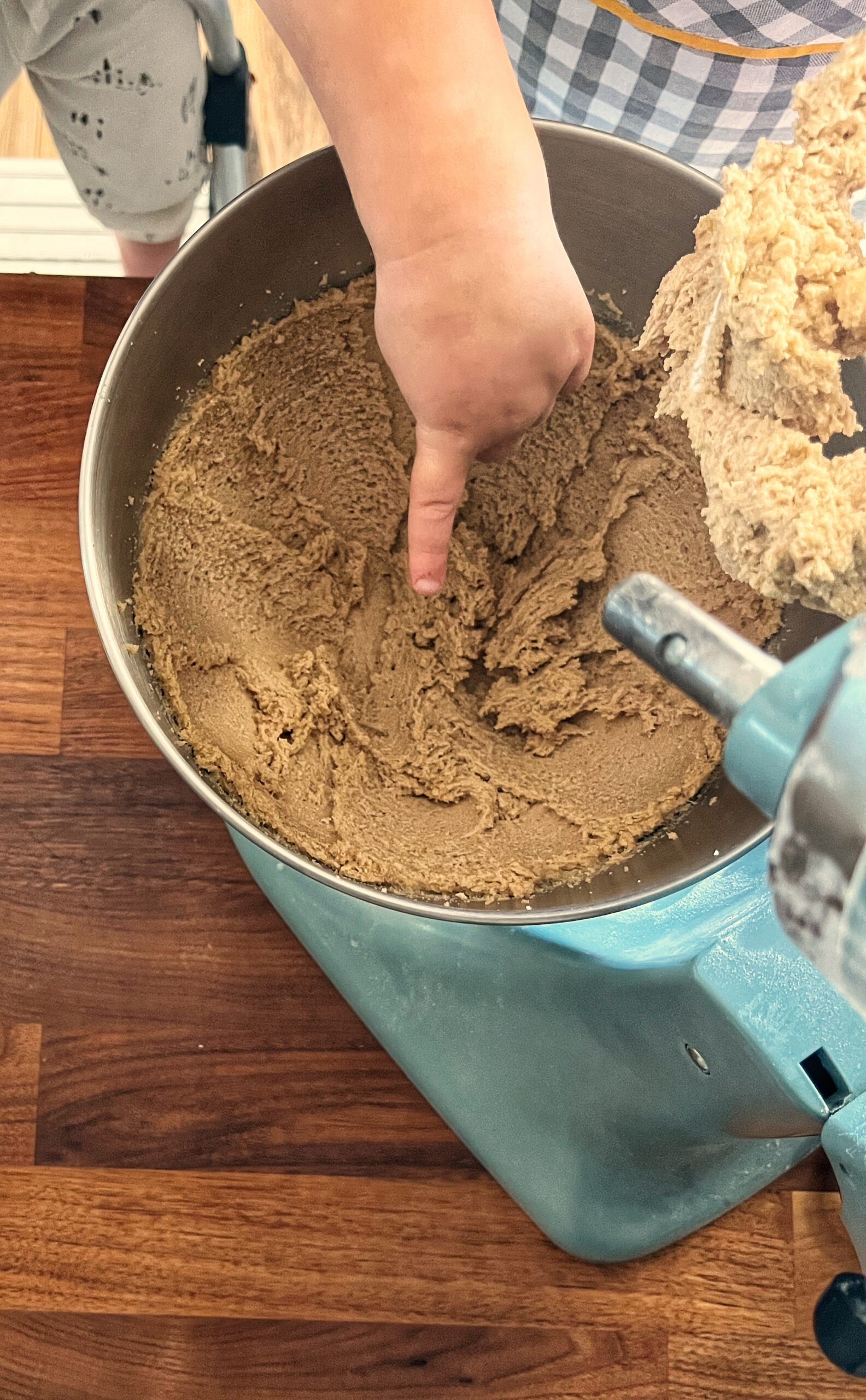 butter and sugar whipped together in stand mixer with toddler pointing