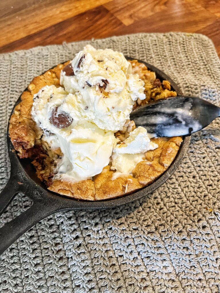 chocolate chip pizookie finished with ice cream and spoon