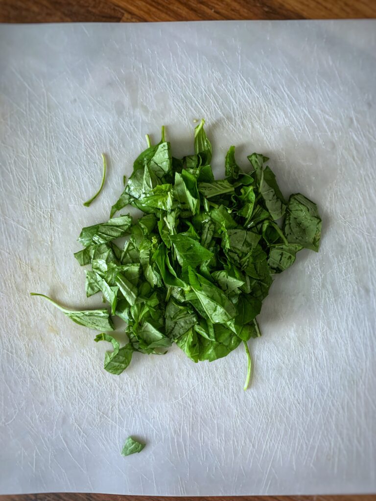 chopped basil on cutting board