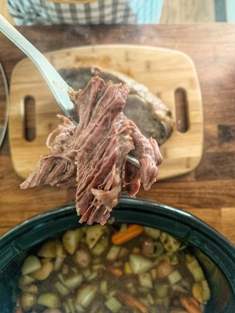 shredded beef with crock pot in background