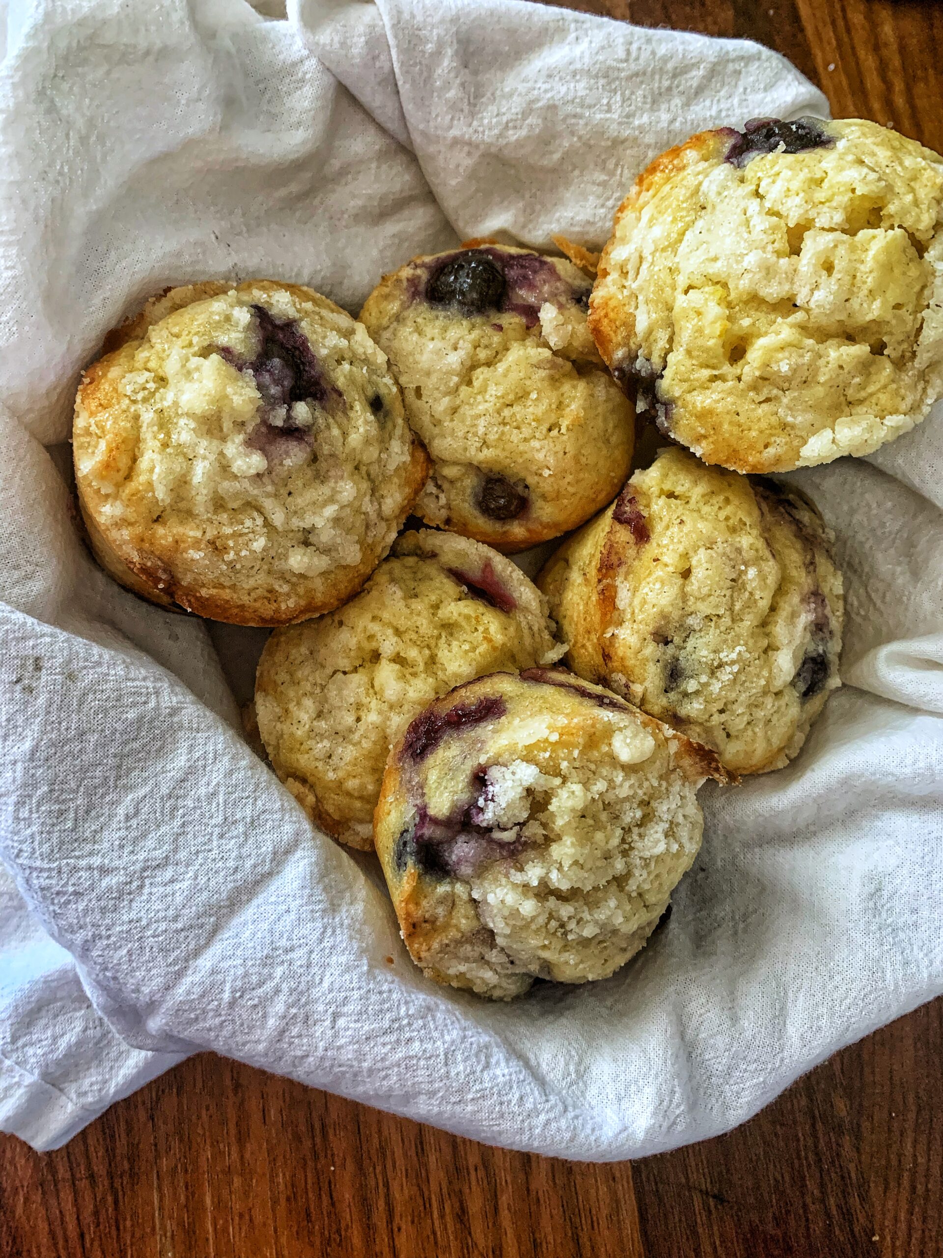 Magnolia table blueberry muffins with streusel topping on white towel