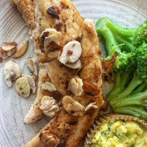 chicken fingers with almonds and muffin and broccoli