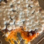 marshmallow topped sweet potato casserole in glass dish